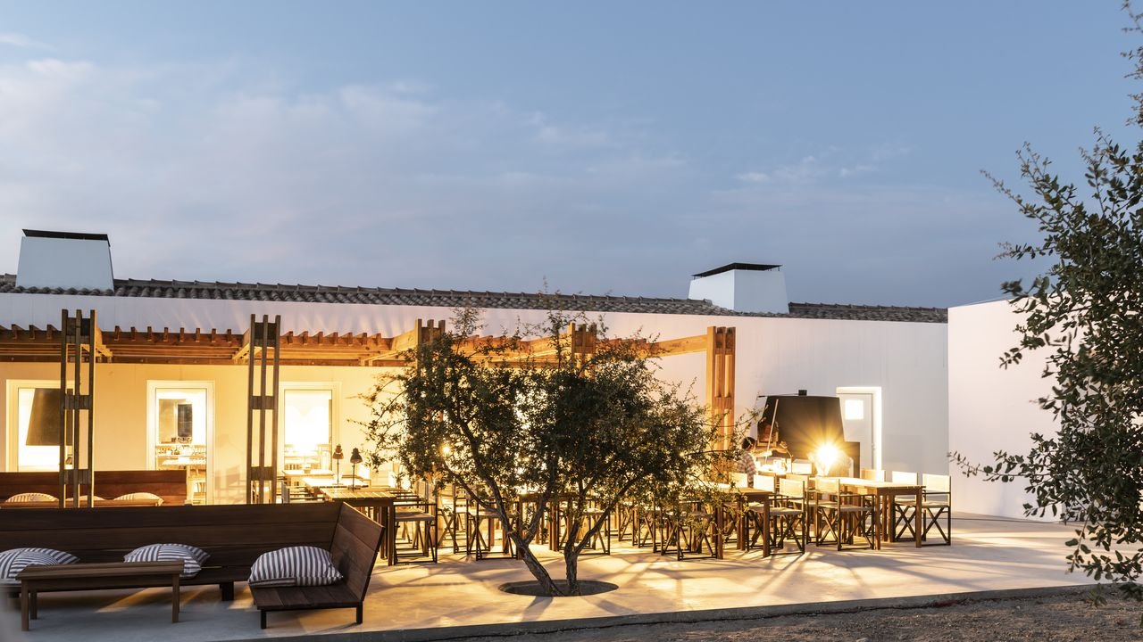 Communal dining at dusk with twinkling lights