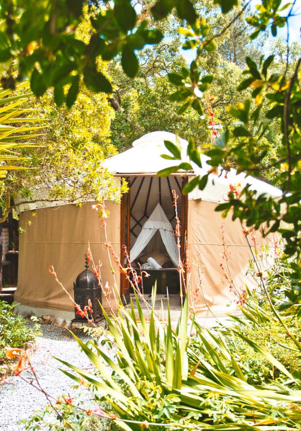 Yurt interior with double bed and singles at Aterra