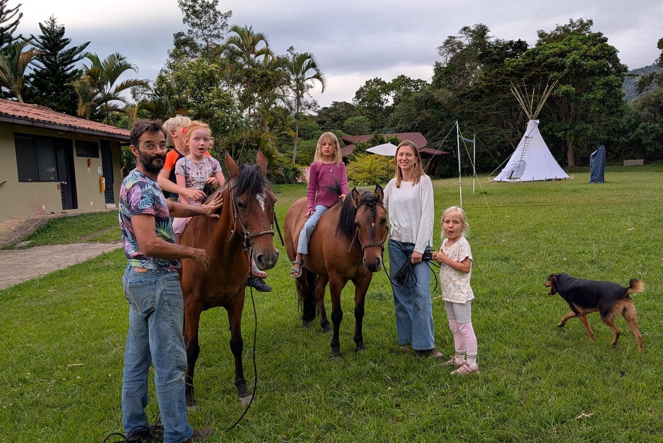 Children on horses with tipi in background at Casa Sumapaz