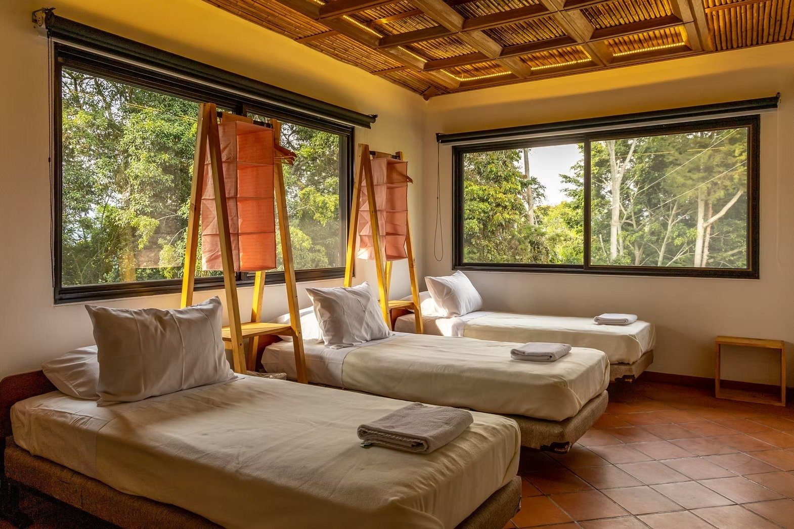 Triple bedroom with handcrafted ladder wardrobes overlooking the jungle