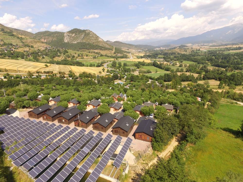 Aerial view of Cerdanya Viva showing solar panels, lodges and the Cerdanya valley