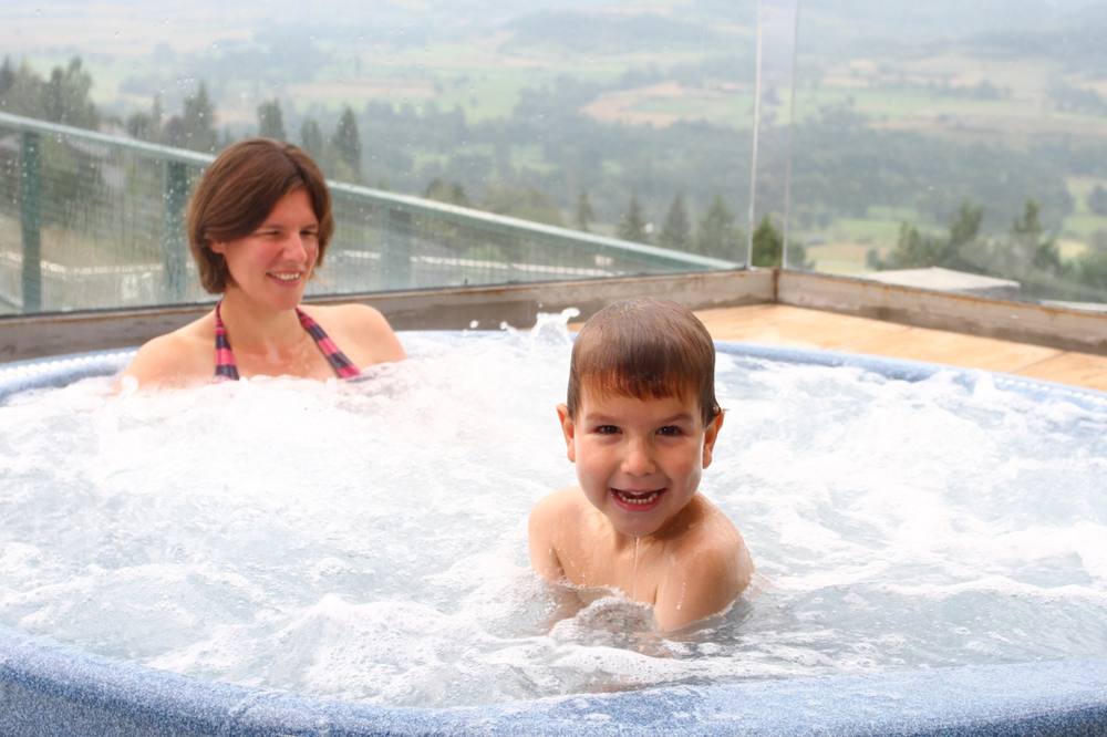 An adult and a small child together in the heated pool at Cerdanya Viva